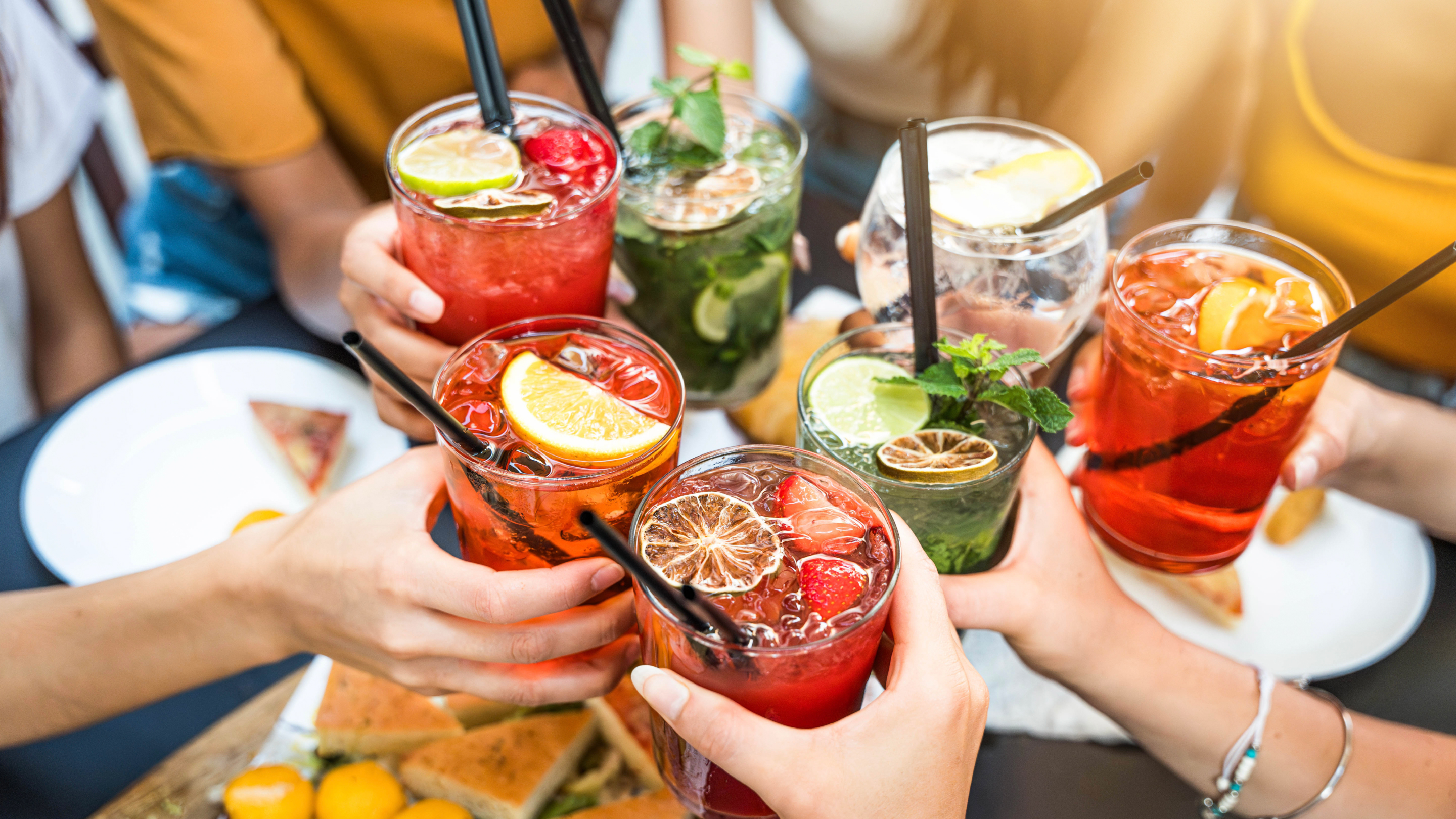 A group of friends holding an array of mocktails.